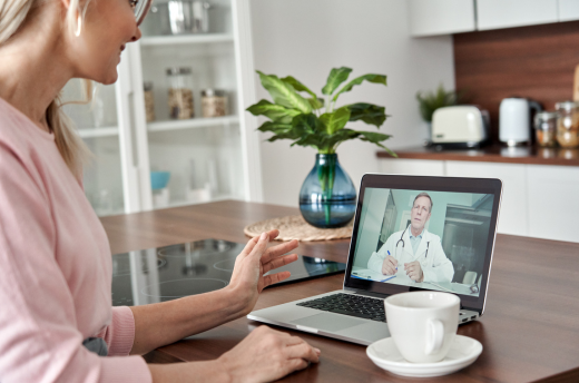 woman talking to doctor via video chat on computer